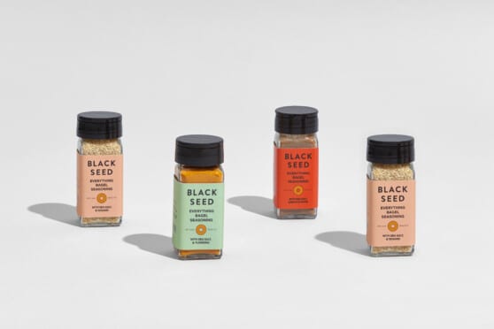four bottles of Black Seed Bagels Everything Seasoning in orange, green, and red labels