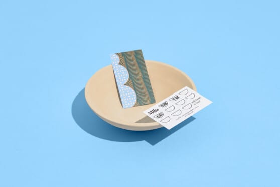 milu business cards in a bowl on blue background